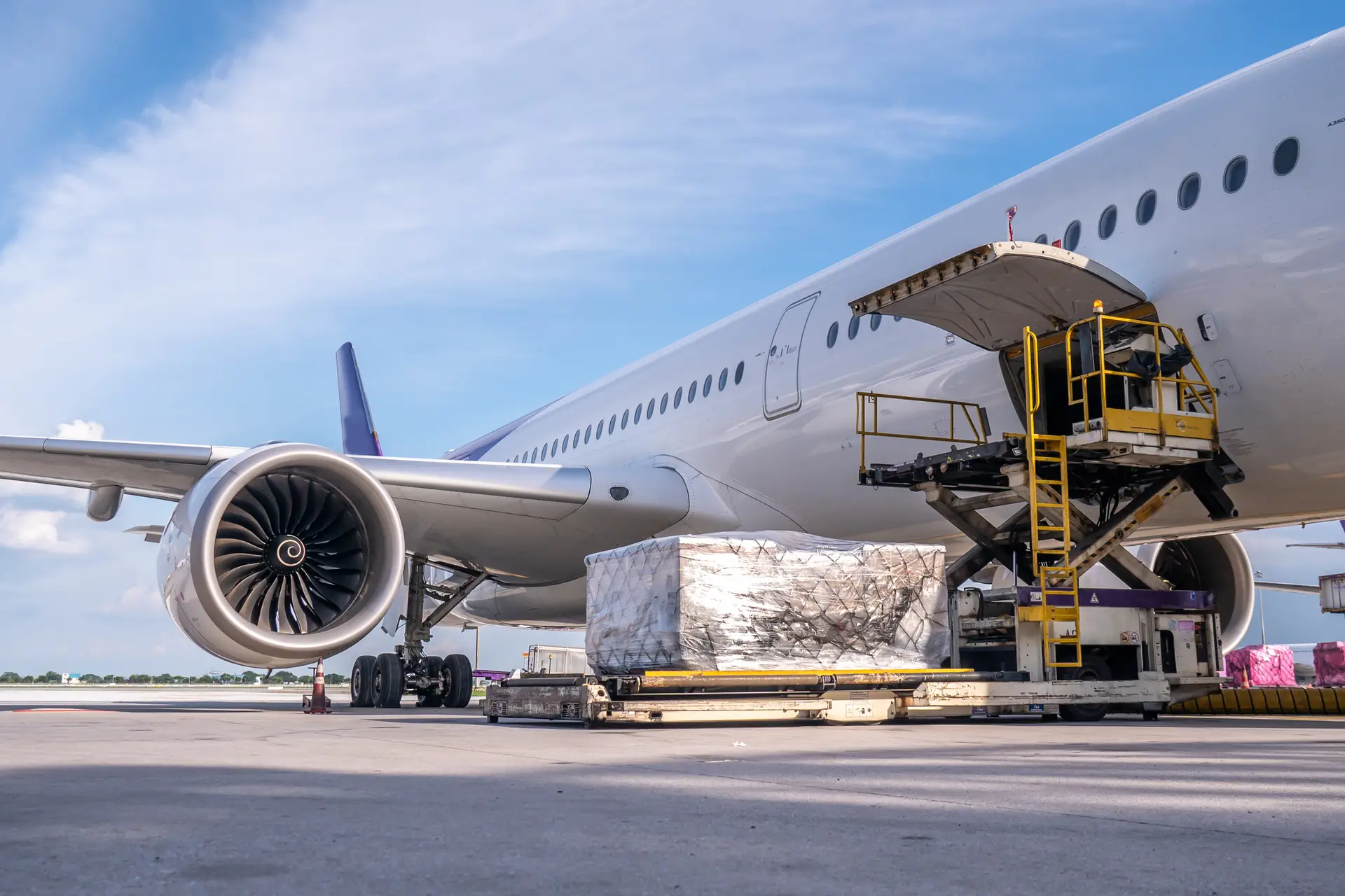Air cargo logistic containers are loading to an airplane. Air cargo logistic containers are loading to an airplane. Air transport shipment prepare for loading to modern freighter jet aircraft at the airport.